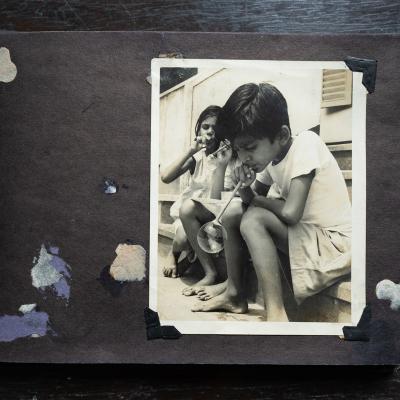 Old Family Photo Of Children Playing Around The House