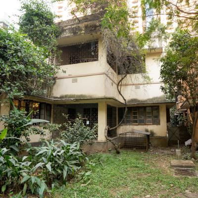 The Humble Presence Of The House With The Background Of Multistoried Buildings